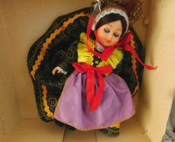 5.5" INTERNATIONAL COSTUMED BRUNETTE DOLL, PURPLE APRON, HEADDRESS  IN BOX